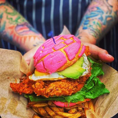 Fried chicken sandwich on concha bun, served with fries