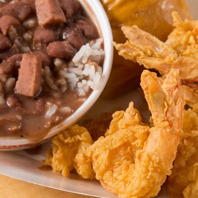 Fried shrimp, served with red beans and rice.