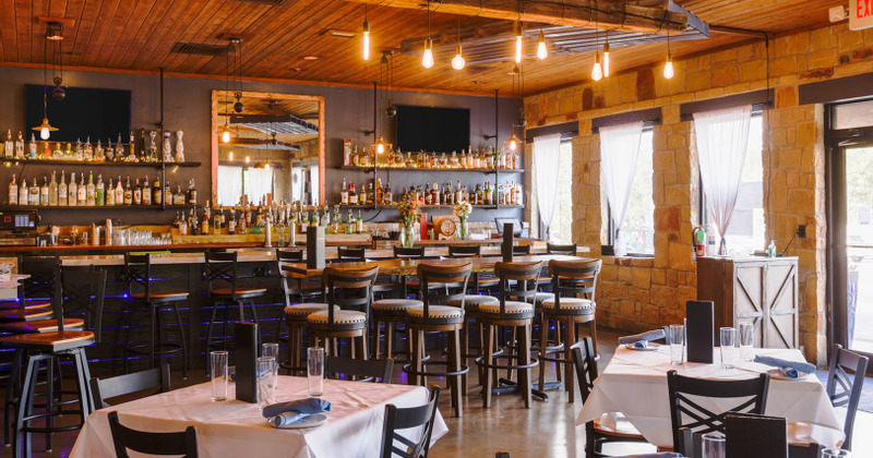 Interior, dining tables in the front and the bar in the back