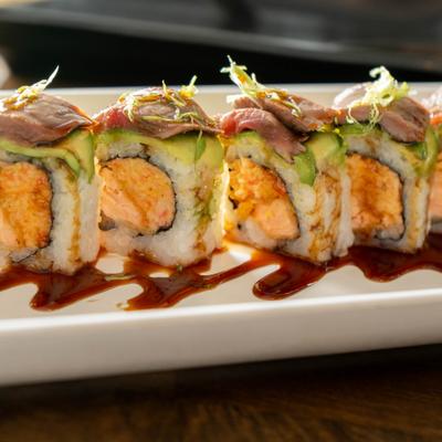 Surf and Turf Roll topped with sliced seared beef and avocado.