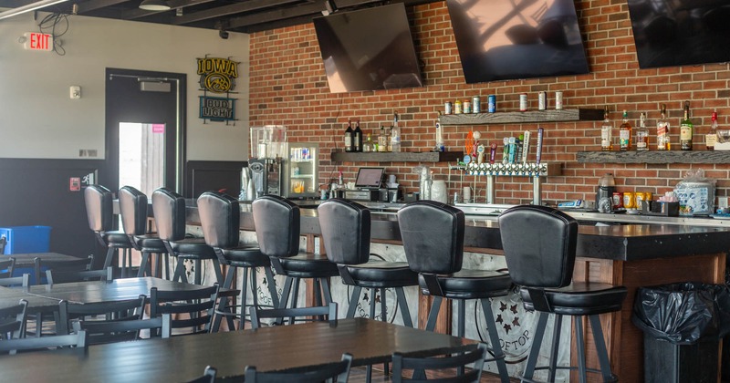 Interior, upstairs, bar with bar chairs, tables, TVs
