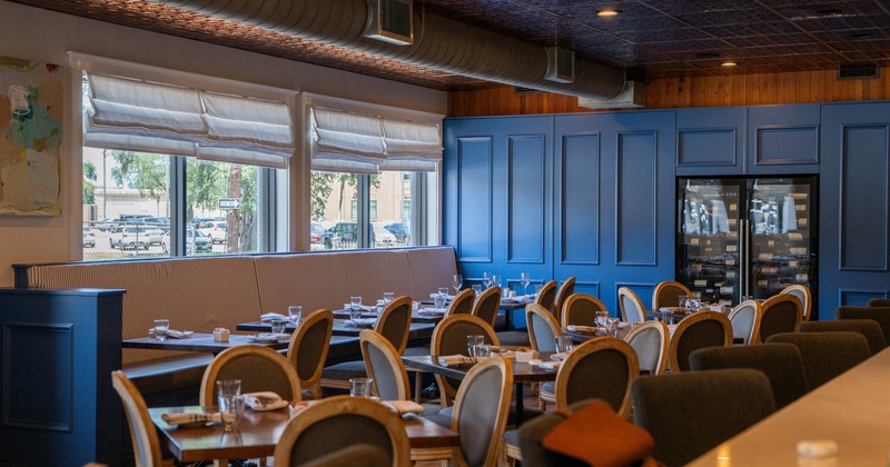 Interior, dining area, tables for four, banquette bench with tables and chairs