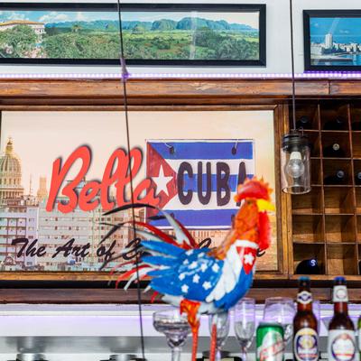 A framed poster with the 'Bella Cuba' sign in the bar area.