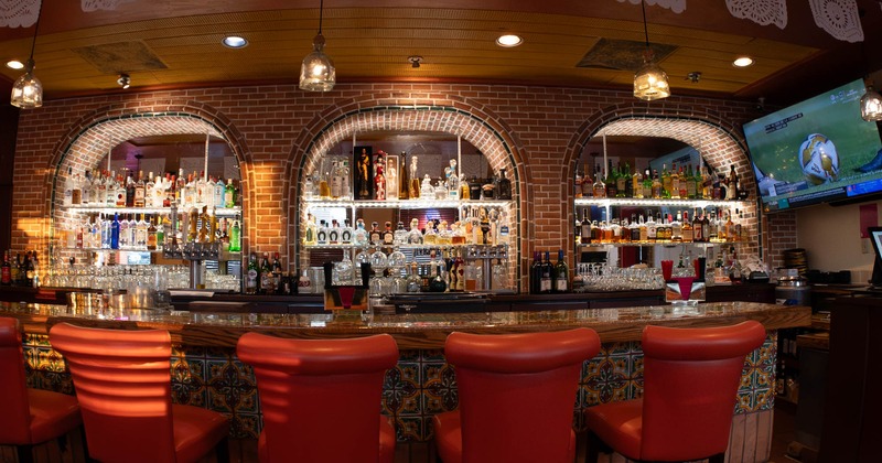 Interior, bar area, wooden top bar with stools, large drink shelves, red brick wall