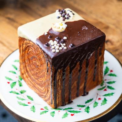 A cube croissant on a decorative plate.