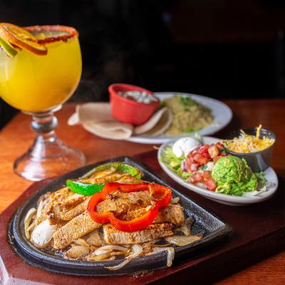 Chicken fajitas with sides and Margarita.