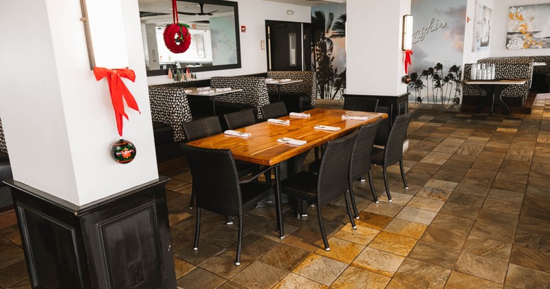 Interior view of a restaurant with a decorated dining area, featuring a wooden table