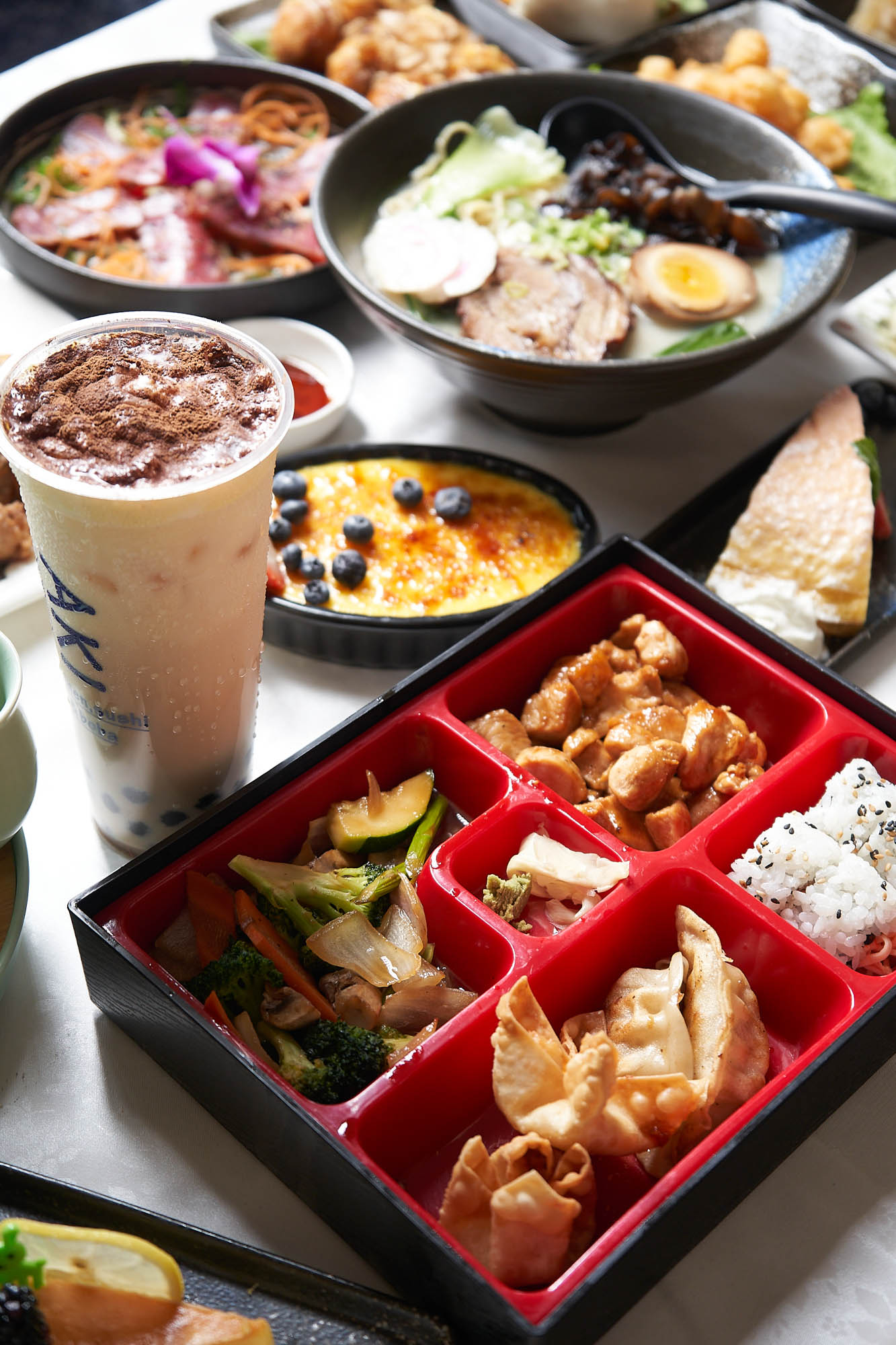 Chicken Teriyaki Bento Box with different food plates on the table