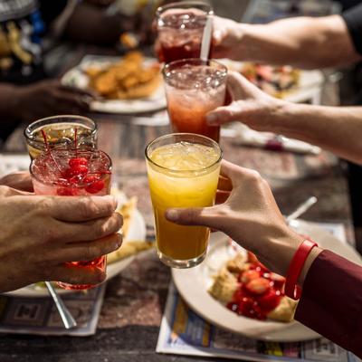 Customers toasting with drinks.