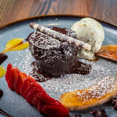 Smoked, salted caramel sauce dessert with whipped creme and fresh berries.