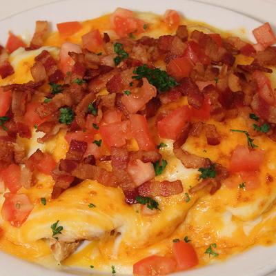 Hot Brown sandwich with bacon, tomatoes and a creamy cheese sauce.
