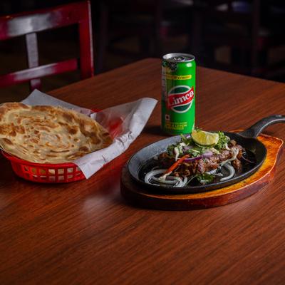 Beef Kebab, with naan bread, and soda.