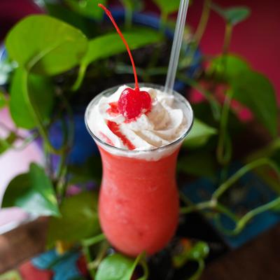 Flavored Margarita, topped with whipped cream and cherry img