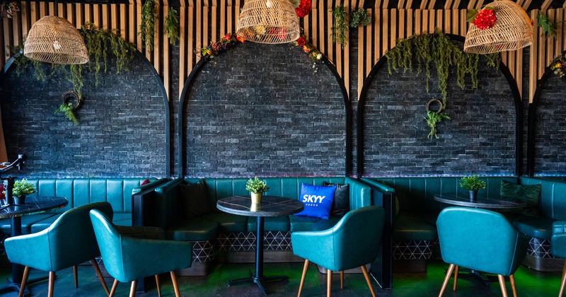 Interior, dining area,  ''U'' shaped seating booths with round tables and chairs