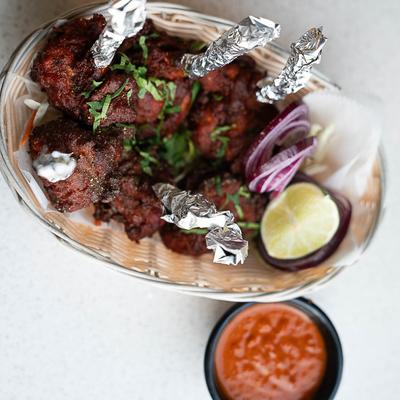 Chicken Lollipops and a condiment on the side.