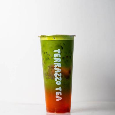 A Terrazzo Tea cup with red at the bottom and green at the top, set against a white background.