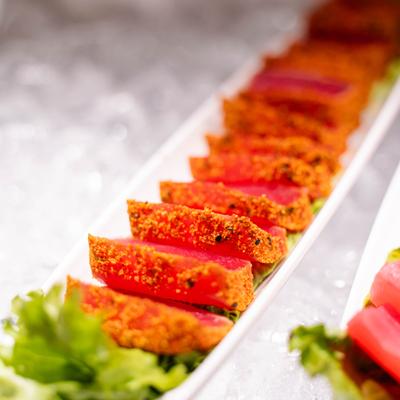Seared tuna tataki plated with lettuce.