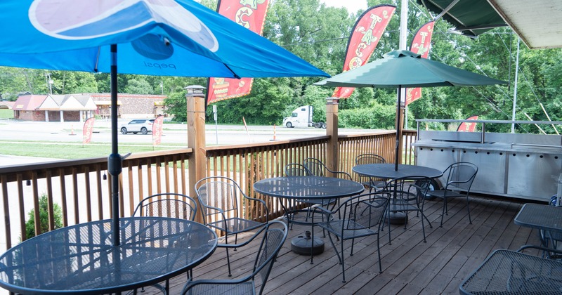 Exterior seating area with chairs, tables and parasols