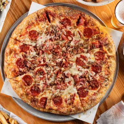 Meat Cravers Pizza served on a metal tray, overhead view.
