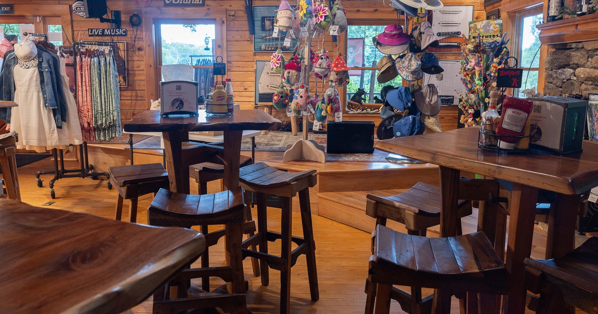 Interior seating area with wooden bar tables and wooden bar stools