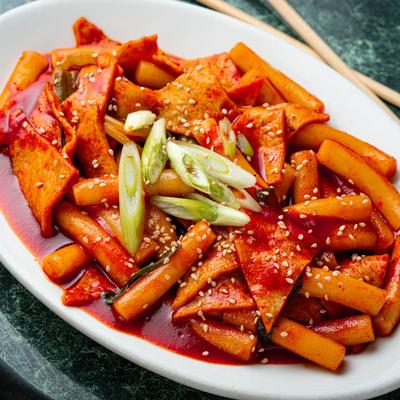 Rice cake dish with scallions, topped with choped spring onion.