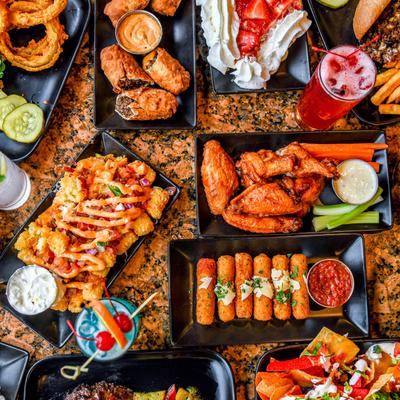 Assortment of dishes and drinks spread on the table, overhead view.