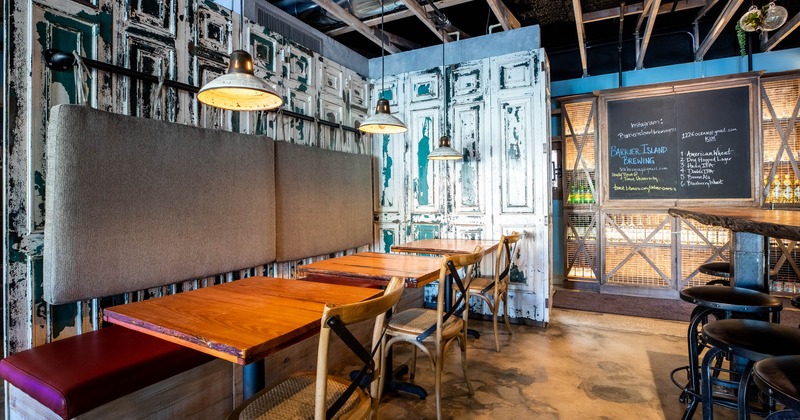 Interior, high back wall seating with tables and chairs