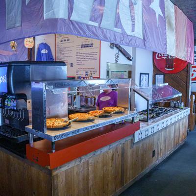 Interior with a pizza display and a salad bar.