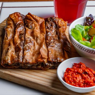 Baked phyllo dough with beef filling served with house salad and pepper and eggplant condiment.
