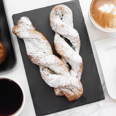 Twisted pastries topped with powdered sugar.