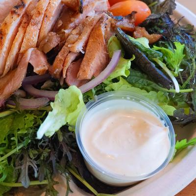 Smoked Chicken Salad, with greens, cranberries, tomato, sunflower seeds, onion, and dressing.