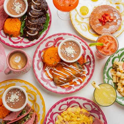 Colorful Mexican breakfast and lunch dishes served on patterned plates.