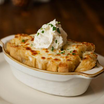 Truffle garlic bread topped with ricotta cheese and herbs.