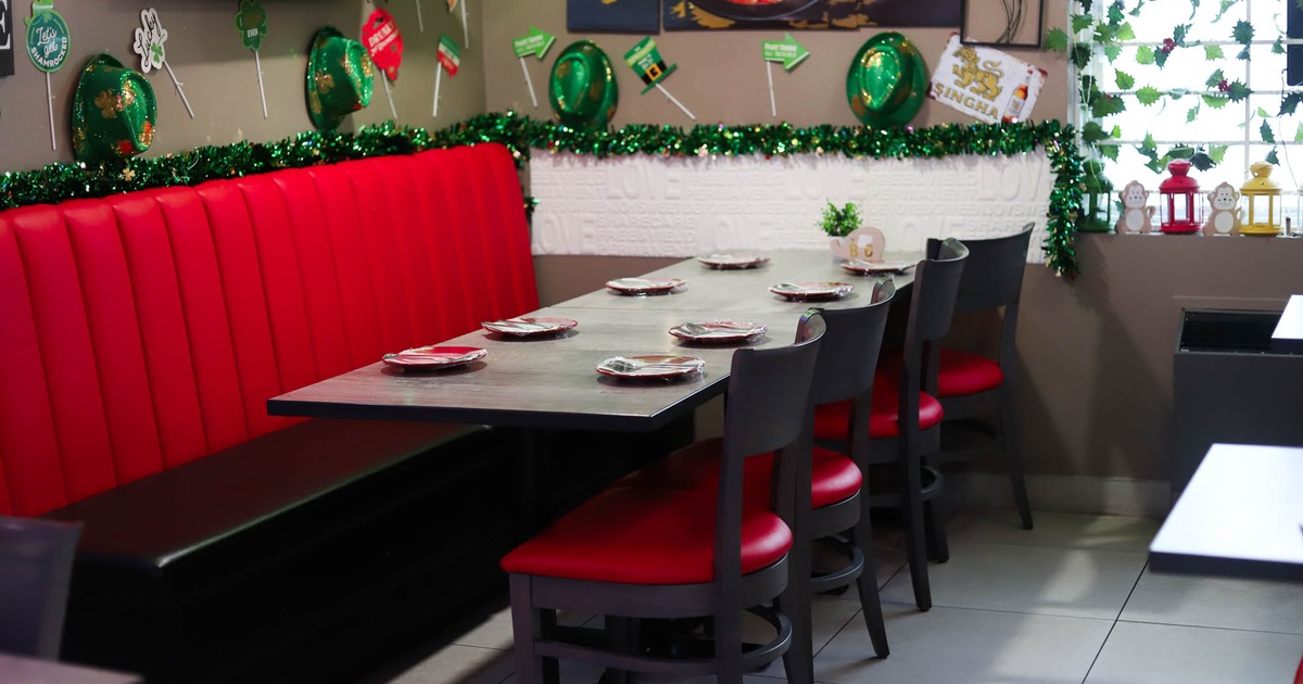 Interior, seating area with a long table, chairs and booths