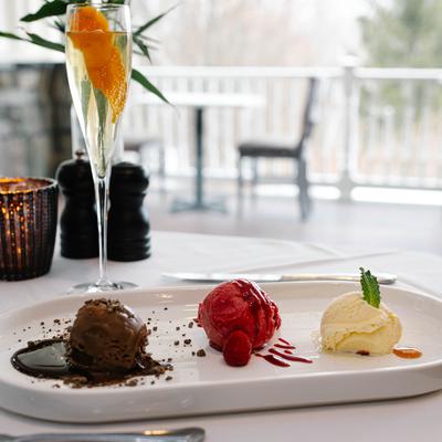 Assorted ice cream scoops served with a glass of champagne.