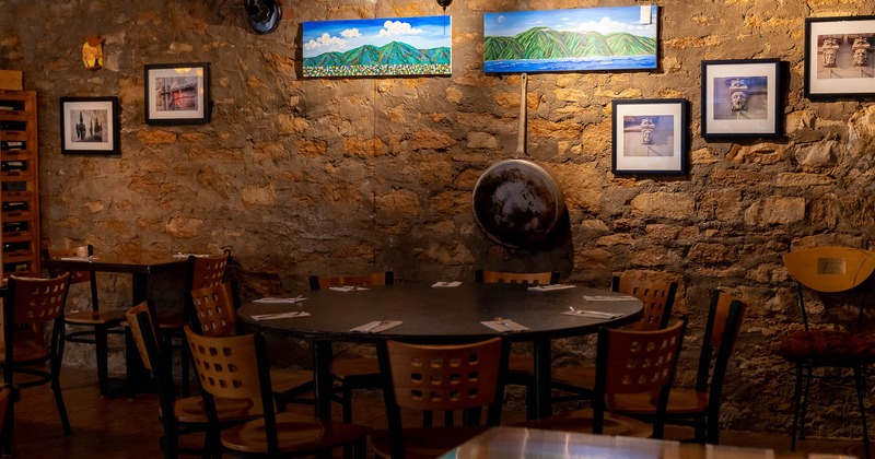 Interior, rounded table by the wall with chairs around it