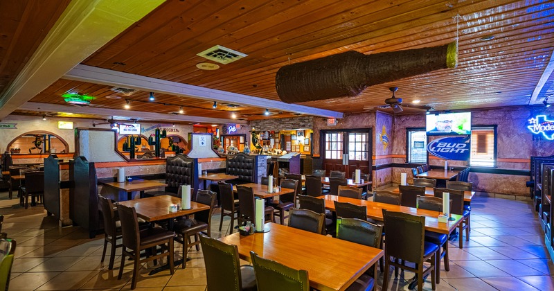 Interior seating area with wooden tables and upholstered seating