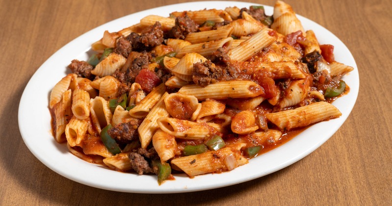 Pasta with sausage, tomato sauce, grilled onions, and peppers
