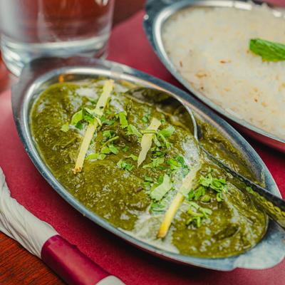 Mustard green spinach cooked with ginger, garlic, and spices, served with steamed rice.