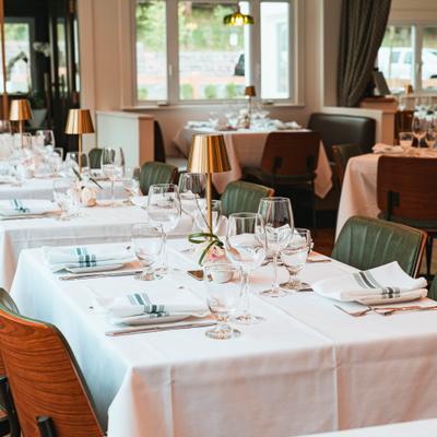 Elegantly set tables with napkins and glassware.