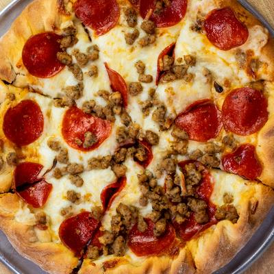 Pepperoni and sausage pizza, top view.