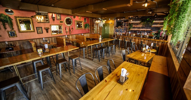 Interior, tables and chairs, decorative leaves on the right