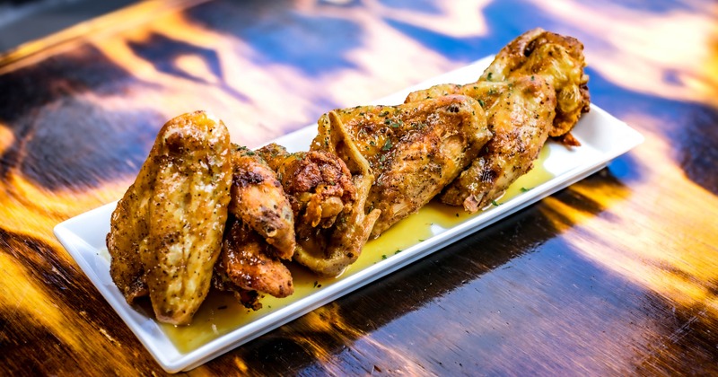 Bourbon Wings served on a white rectangular platter