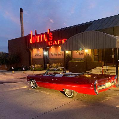 Johnny's Cafe, exterior with a parked Cadillac Coupe Deville in front