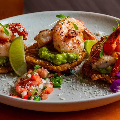 Fried plantains with shrimp guacamole, cotija cheese, pico de gallo, and chipotle sauce.