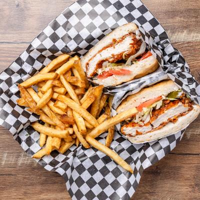 Fried chicken sandwich with fries, top view.