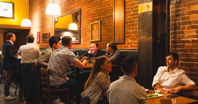 Interior space, seating area full of guests chatting and enjoying their drinks