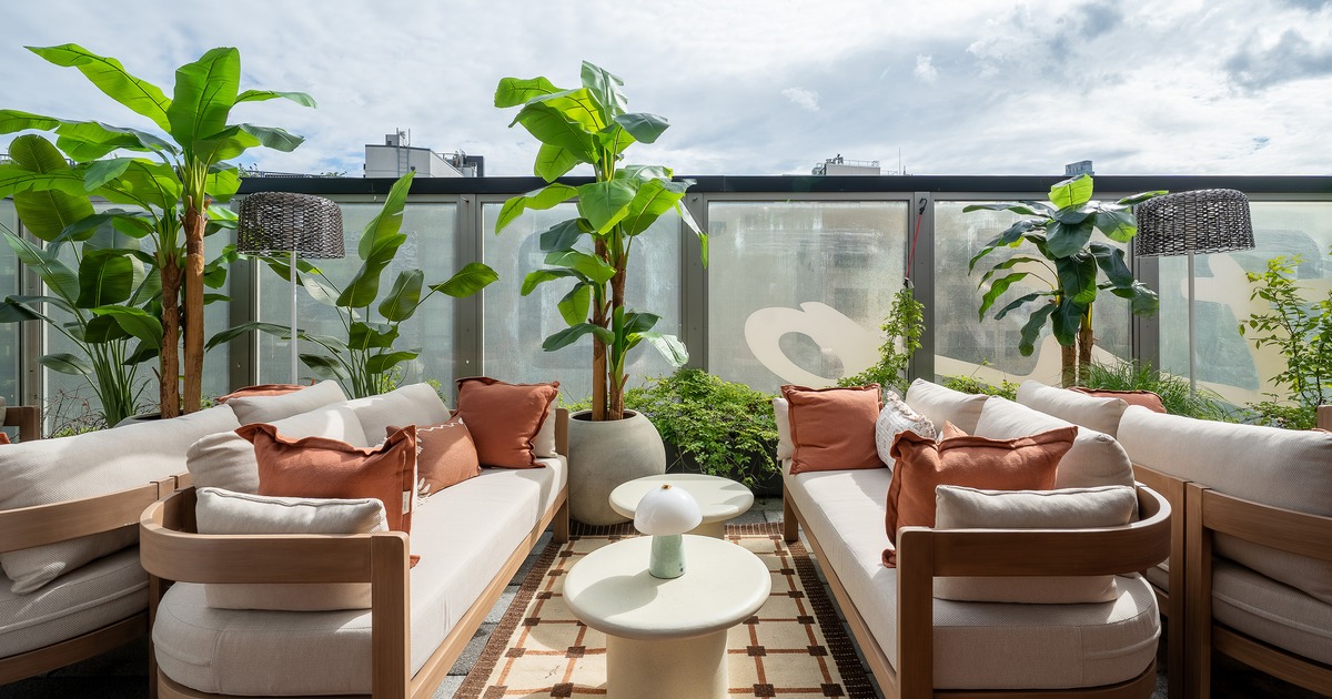 Modern rooftop lounge and outdoor seating area with comfortable sofas and low tables