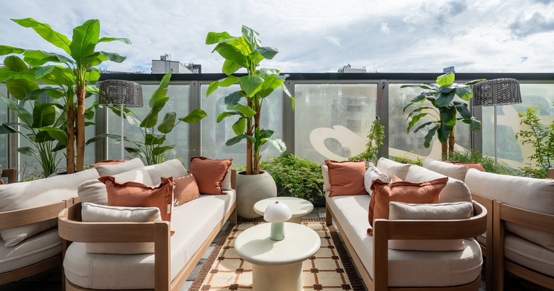 Modern rooftop lounge and outdoor seating area with comfortable sofas and low tables