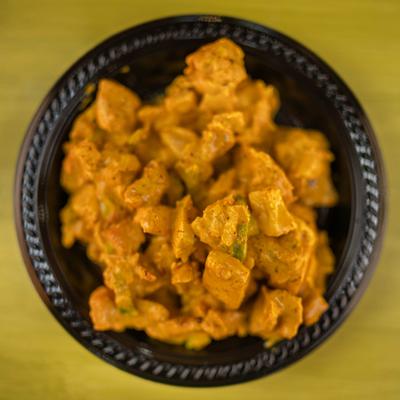 Curry Chicken Salad served in a small black plate, overhead view.